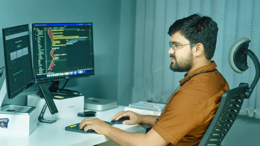 a man sitting at a desk using a computer