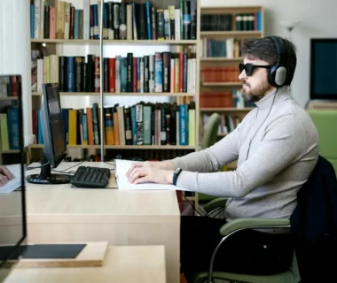 A man sitting at a desk with headphones on