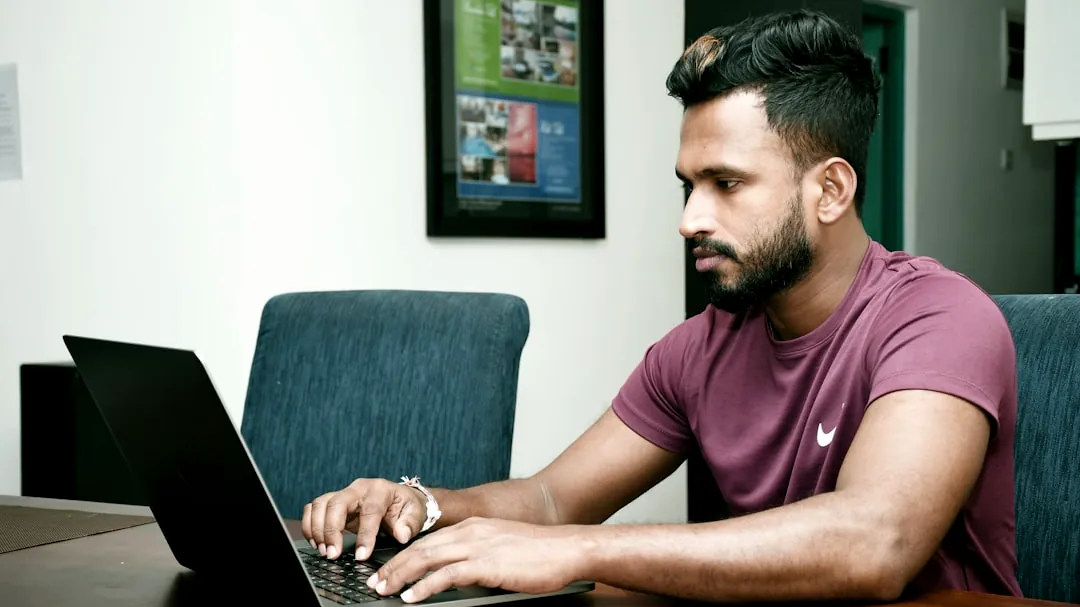 a man sitting in front of a laptop computer
