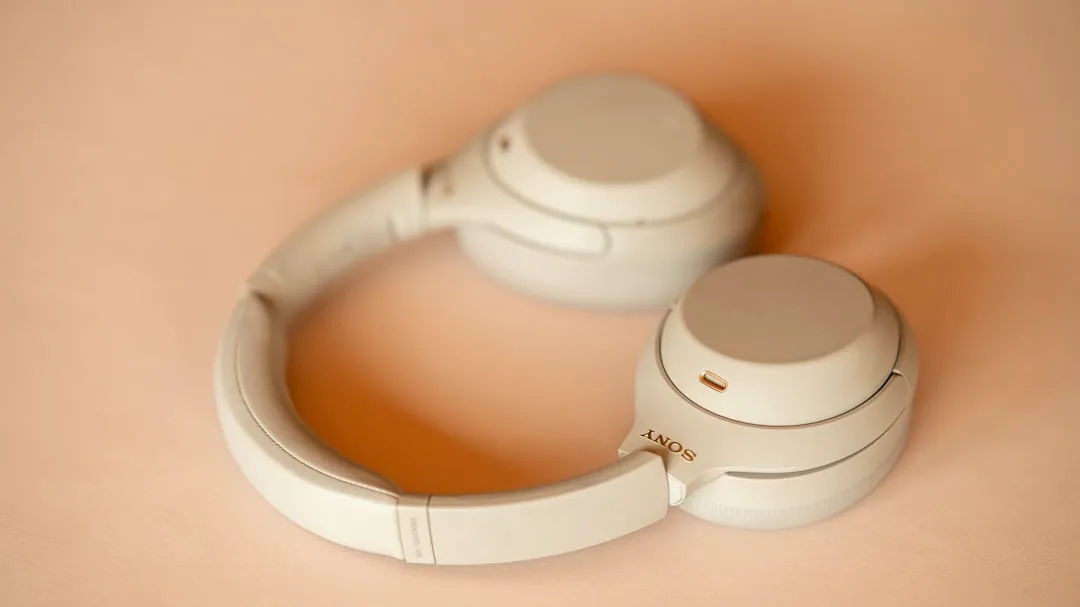 a pair of white headphones sitting on top of a table