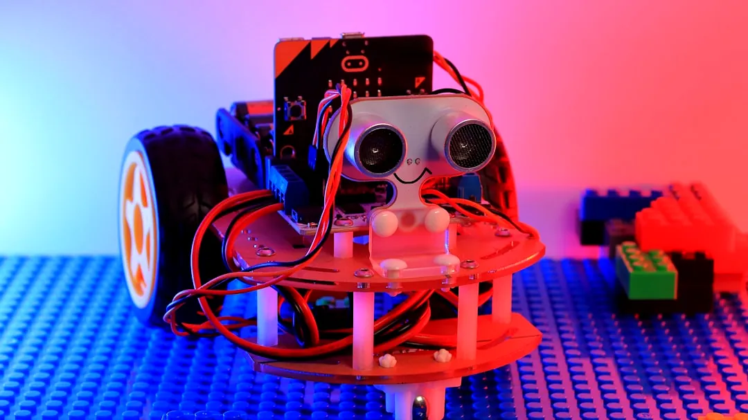 A robot made out of legos sitting on top of a table