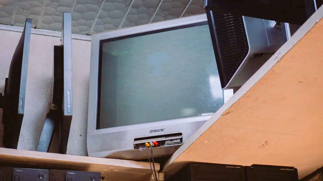 A room with two televisions and a keyboard