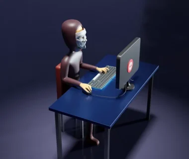a skeleton sitting at a desk with a laptop and keyboard