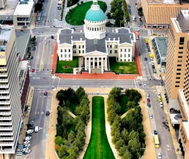 A stunning aerial view of the historic Old Courthouse in downtown St. Louis surrounded by city buildings.
