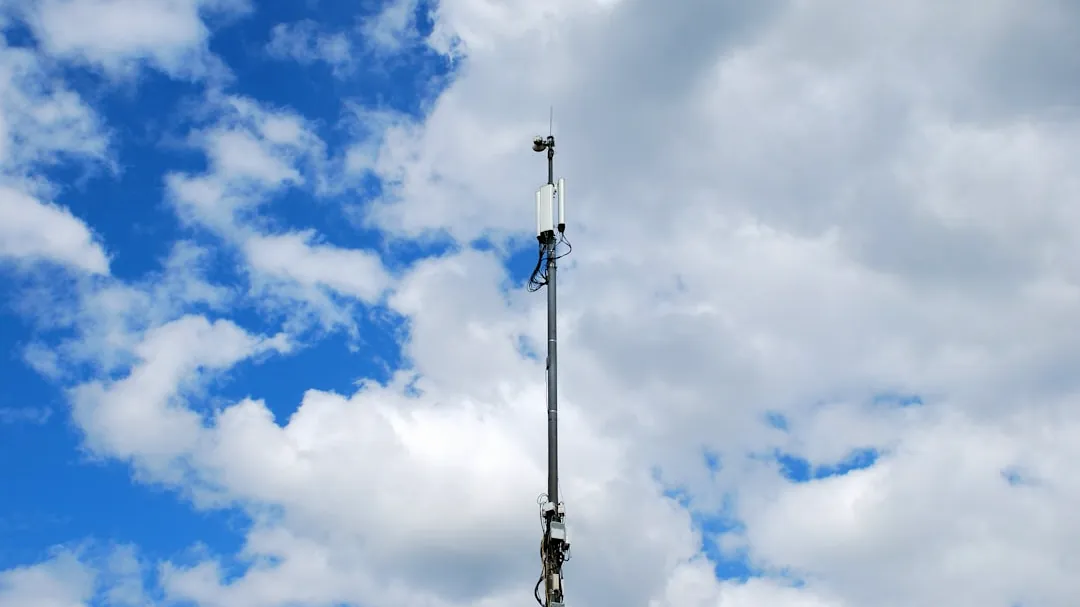 a very tall antenna on a cloudy day
