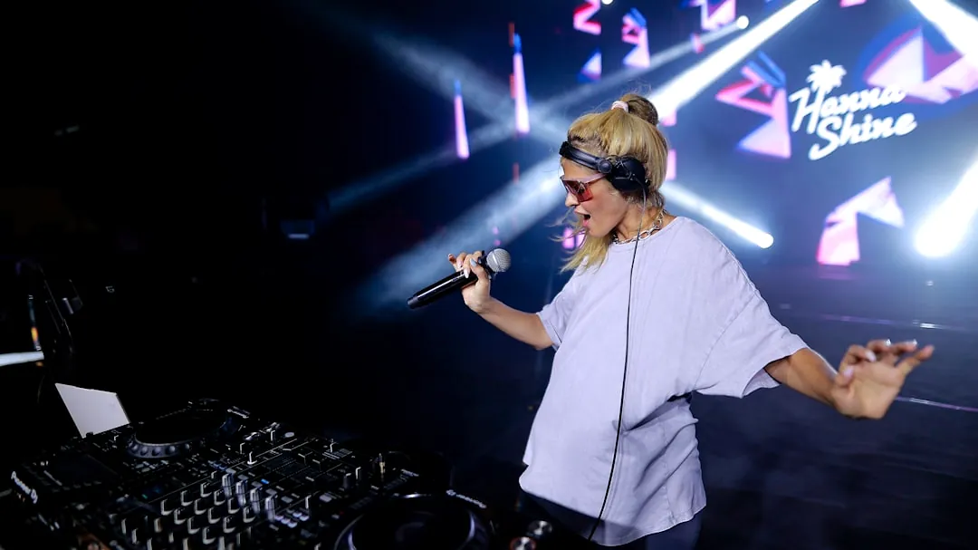 A woman standing in front of a dj set