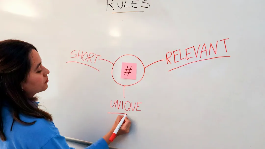 a woman writing on a whiteboard with a marker