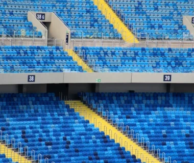 Empty blue stadium seats with yellow accents