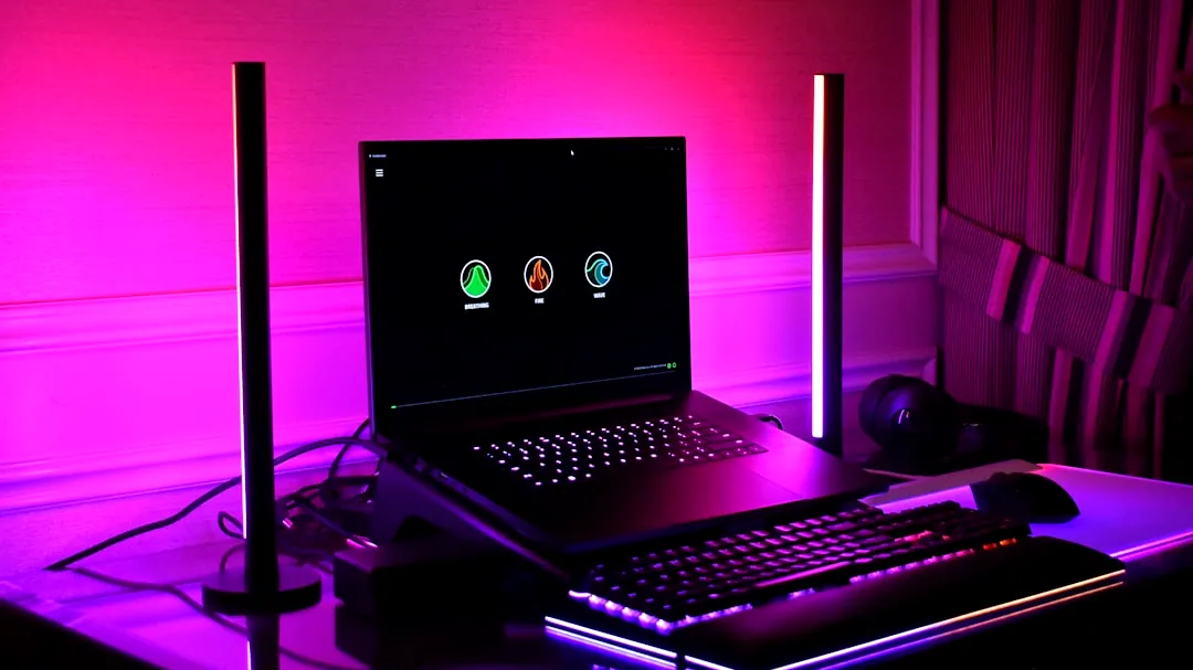 Gaming setup with laptop, keyboard, and rgb lighting.