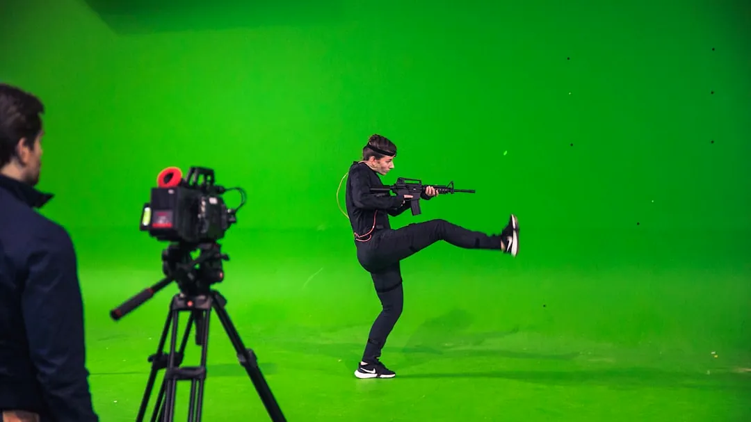 man in black jacket and black pants holding black dslr camera