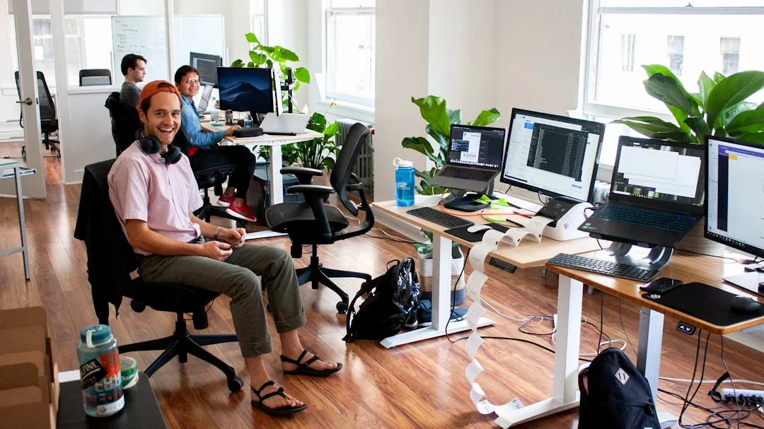 man in blue dress shirt sitting on black office rolling chair