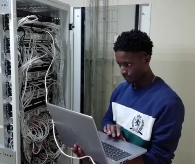 man in blue sweater using silver macbook