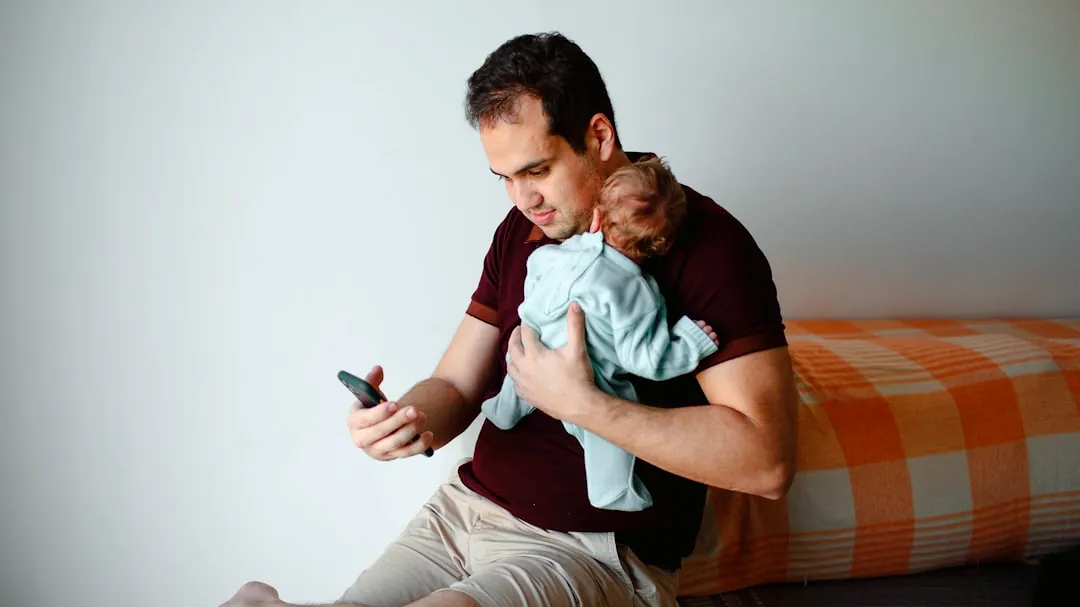 man in green shirt carrying baby