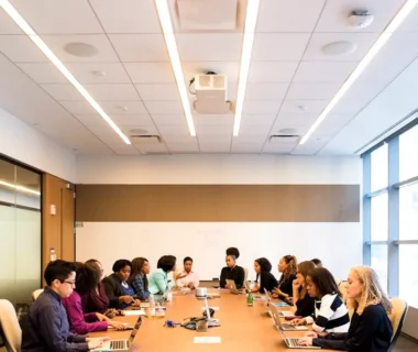 people having meeting on rectangular brown table