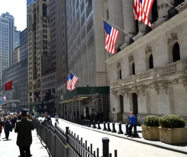 people walking on a street with flags