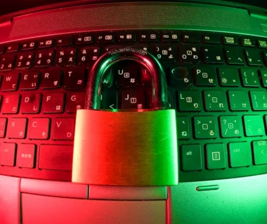 pink and silver padlock on black computer keyboard