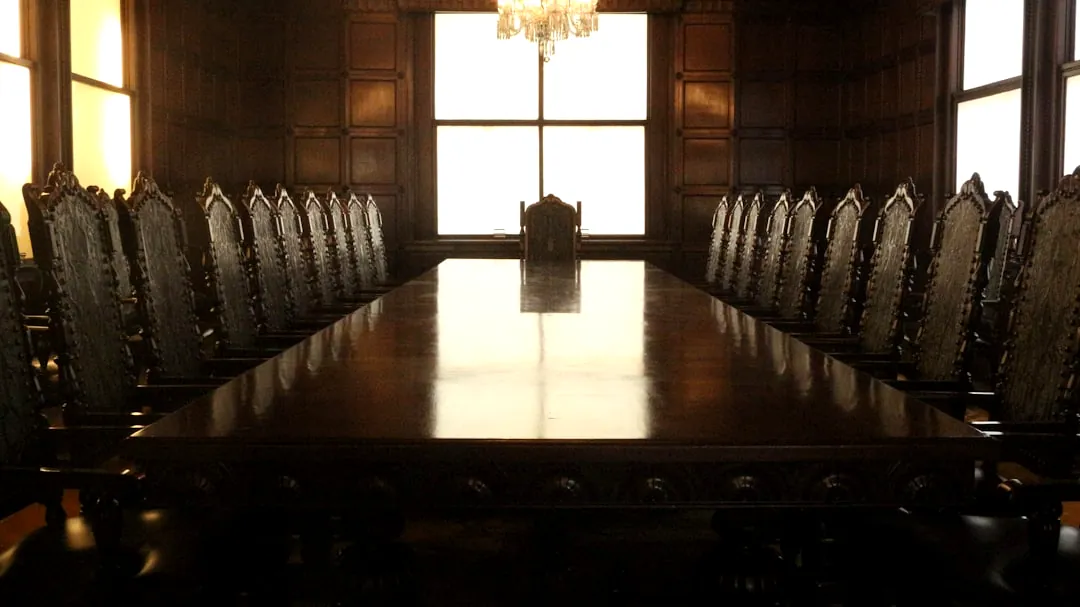 rectangular brown wooden table with chairs
