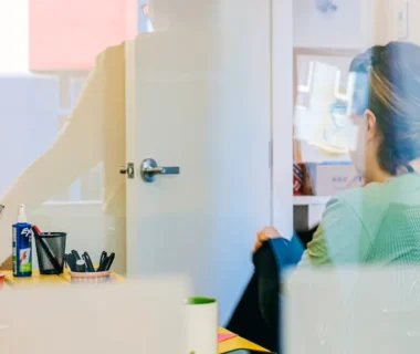 Woman working at a desk through glass