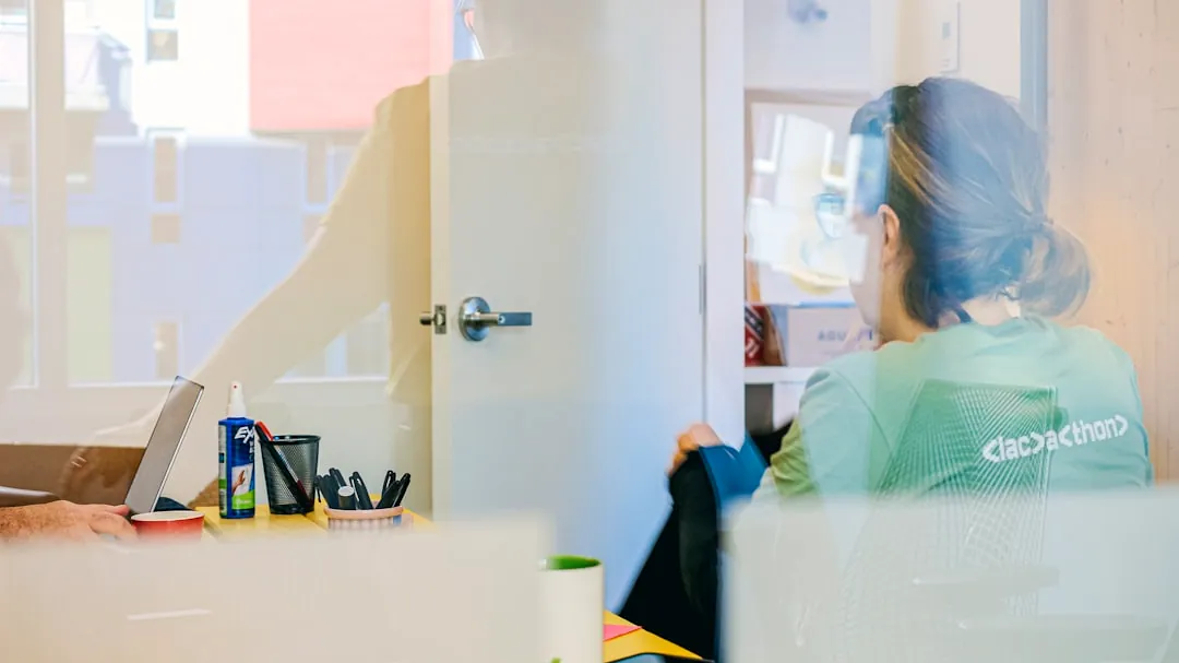 Woman working at a desk through glass