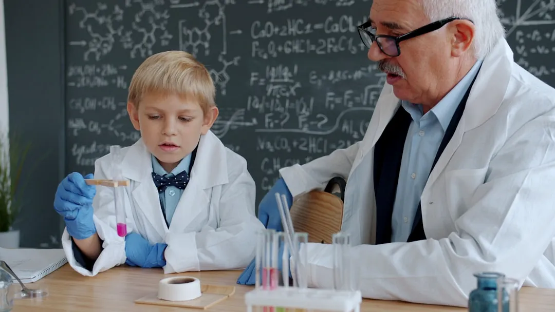 Young boy and older man in lab coats experiment