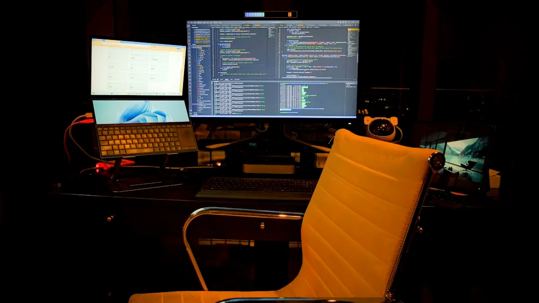 a computer desk with two monitors and a laptop