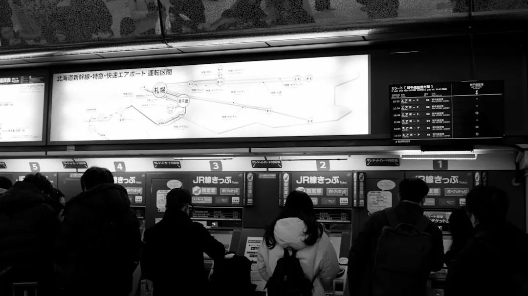 A group of people standing in front of a large screen