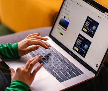 a woman sitting on a couch using a laptop computer