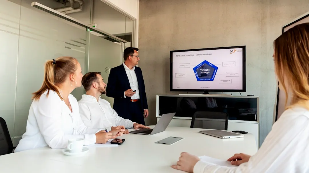 Business meeting with a presenter and colleagues in office.