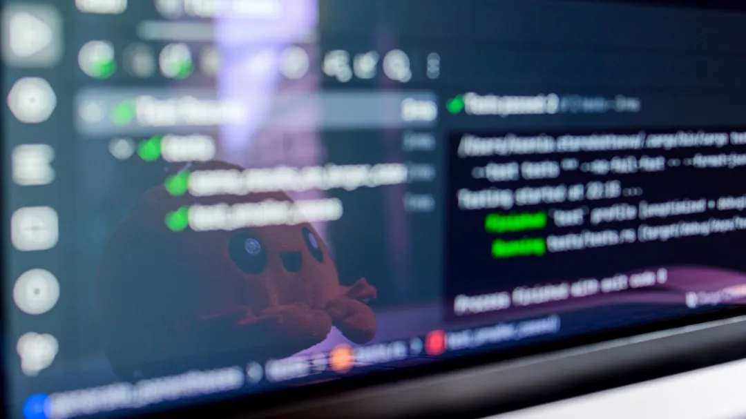 Computer screen displaying code with a toy reflected.