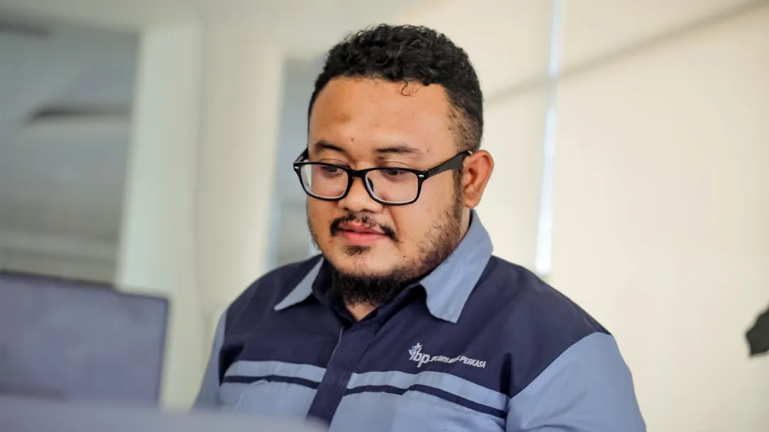 man in blue and black striped polo shirt wearing black framed eyeglasses