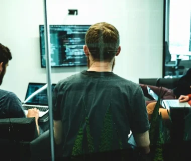 man in green crew neck shirt sitting on chair