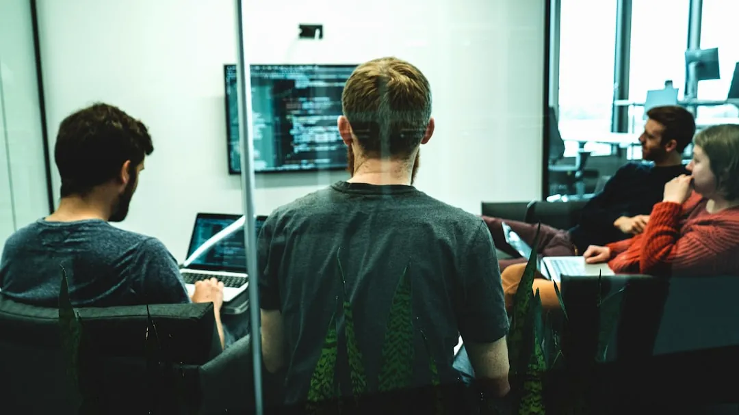 man in green crew neck shirt sitting on chair