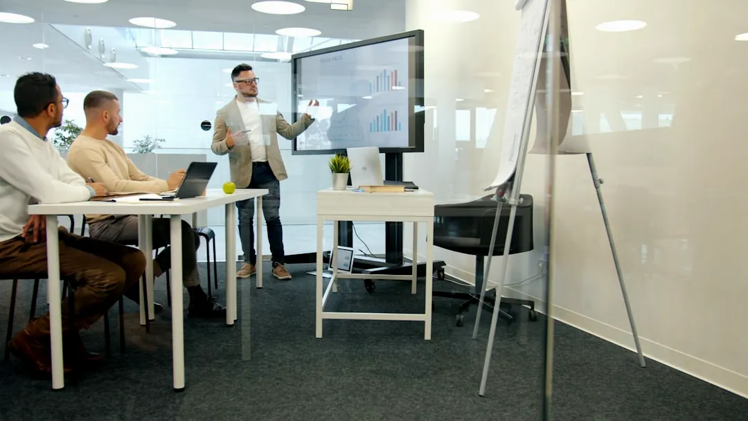 Man presenting to colleagues in a modern office.