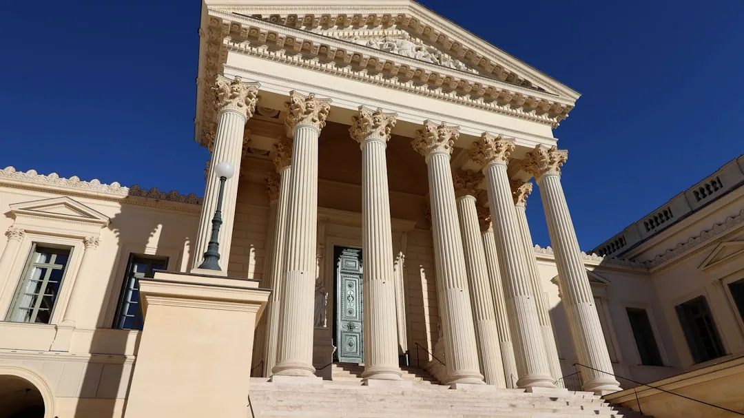 a building with columns and a clock on the front of it