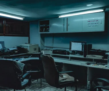 a room with computers and chairs