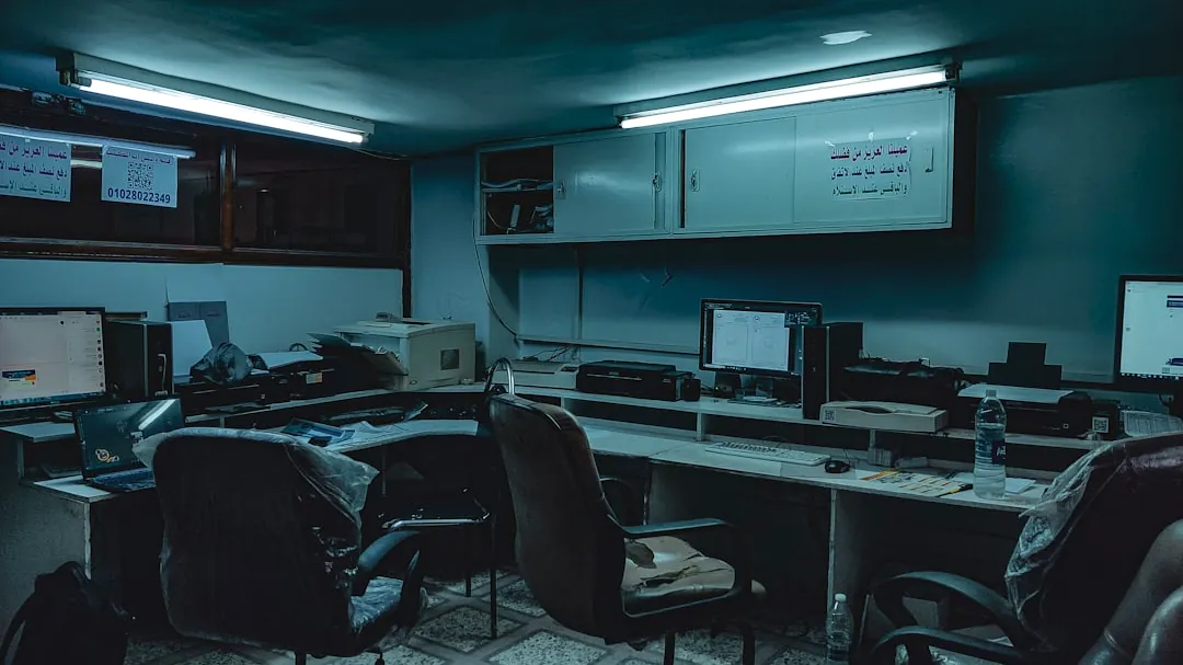 a room with computers and chairs