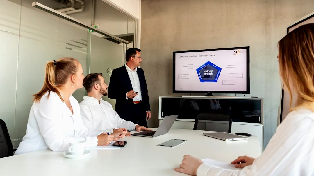 Business meeting with a presenter and colleagues in office.