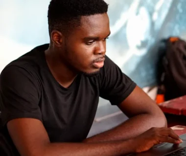 man in gray crew neck t-shirt using laptop computer