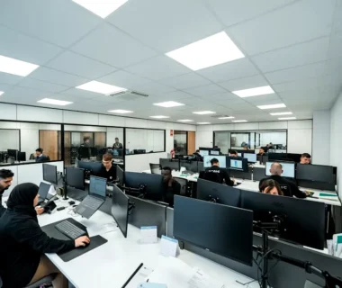 Office workers are busy working on computers.