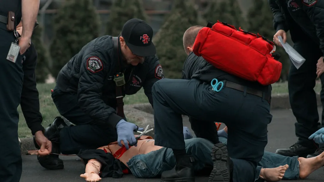 a group of people with a person on the ground