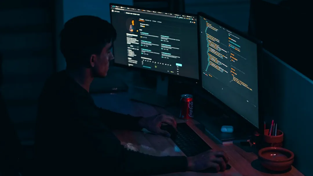 man in black long sleeve shirt using computer